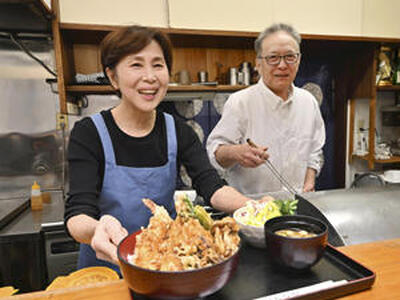 客席に食事を運ぶ淑子さん（左）。調理担当の英明さんと共に客をもてなす（石井裕貴撮影）