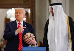 　カタールで開かれた記念行事でサッカーボールを持つトランプ米大統領（左）とタミム首長＝１４日（ロイター＝共同）