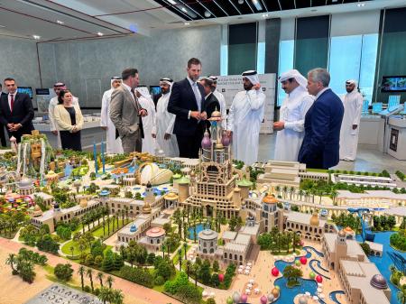 　カタールの閣僚らと共にゴルフ場の３Ｄモデルを視察するトランプ米大統領の次男エリック・トランプ氏（中央）＝４月３０日、カタール・ドーハ（ロイター＝共同）