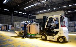 　貨物用コンテナに収容される備蓄米＝３０日午前、東京都大田区