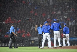 　６回裏途中、降雨で試合が中断し、ベンチに戻るＤｅＮＡナイン。この後、コールドゲームとなった＝マツダ