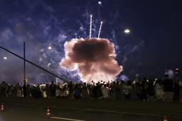 　祭り会場の観衆の近くで爆発する花火＝１８日、デュッセルドルフ（ＤＰＡ提供・ＡＰ＝共同）