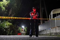 　強盗殺人事件のあった現場周辺で警戒にあたる警察官＝２６日午後１０時５４分、佐賀県伊万里市