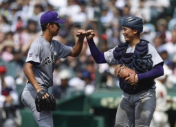 　智弁和歌山に勝利し、タッチを交わす萬谷（左）と高橋蓮の花巻東バッテリー＝甲子園
