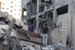 　ガザ北部ガザ市で、イスラエル軍の攻撃により破壊された住宅に集まるパレスチナ人＝２９日（ゲッティ＝共同）