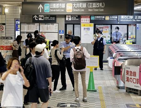 　東急田園都市線溝の口駅で、駅員から説明を受ける人たち＝６日、川崎市高津区