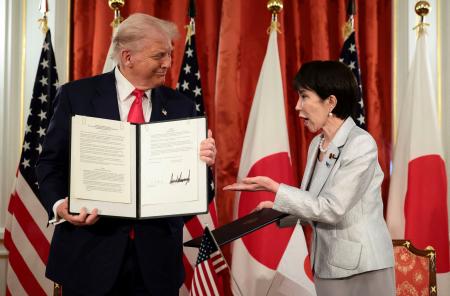 会談後、署名した文書を手にする高市首相(右)とトランプ米大統領=28日、東京・元赤坂の迎賓館(ロイター=共同)