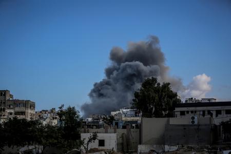 29日、ガザ北部ガザ市で避難民キャンプから立ち上る煙(ゲッティ=共同)